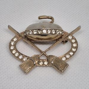VINTAGE Gold Tone Curling Rock And Brooms Themed Brooch with Rhinestones